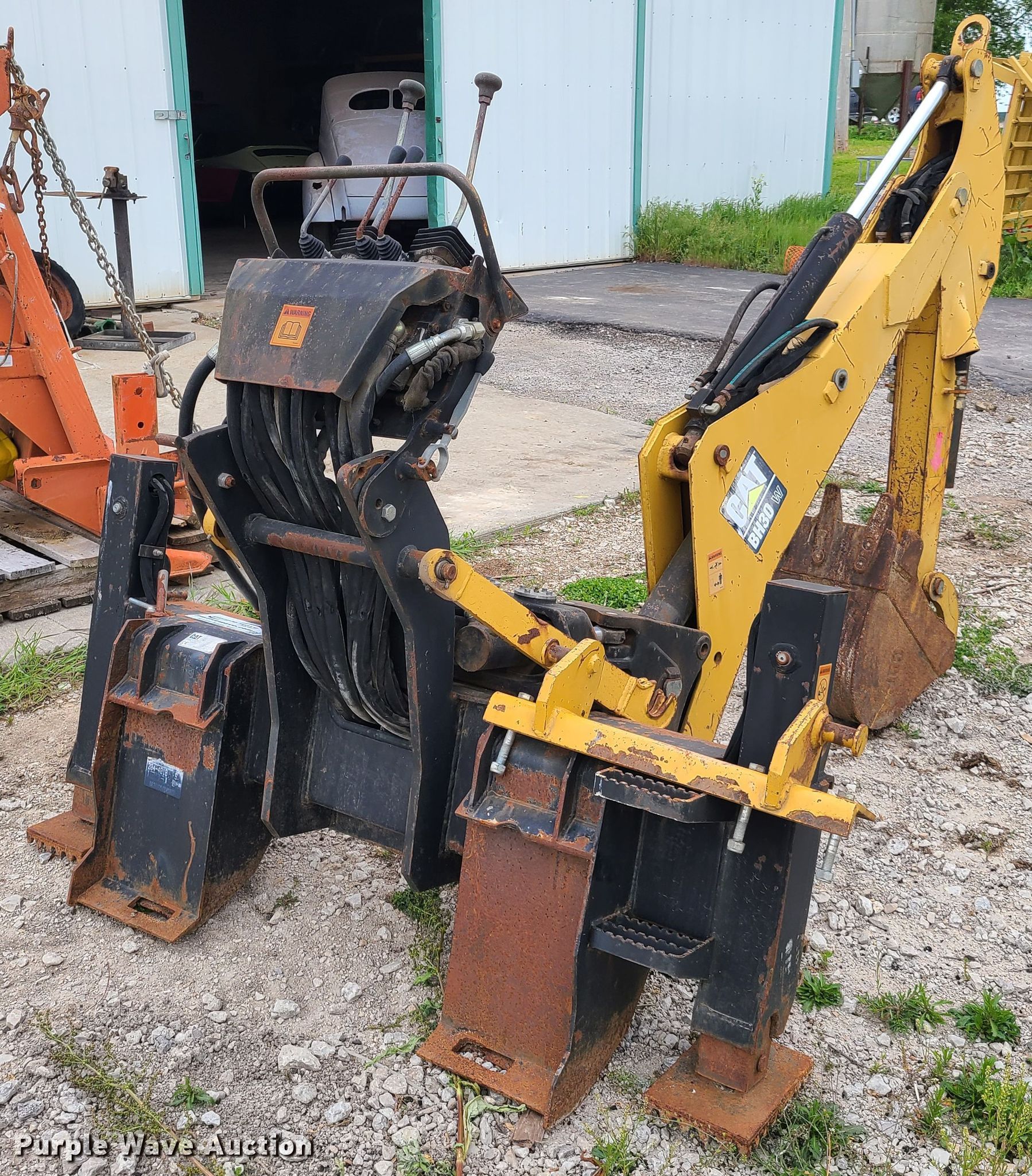 Caterpillar BH30 skid steer backhoe in Richmond, MO Item K5882 sold