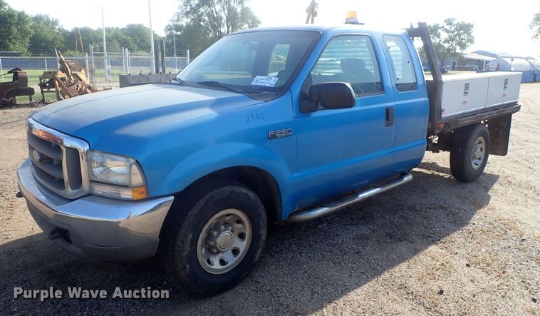 image for item DG2314 2004 Ford F250 Super Duty  SuperCab flatbed pickup truck