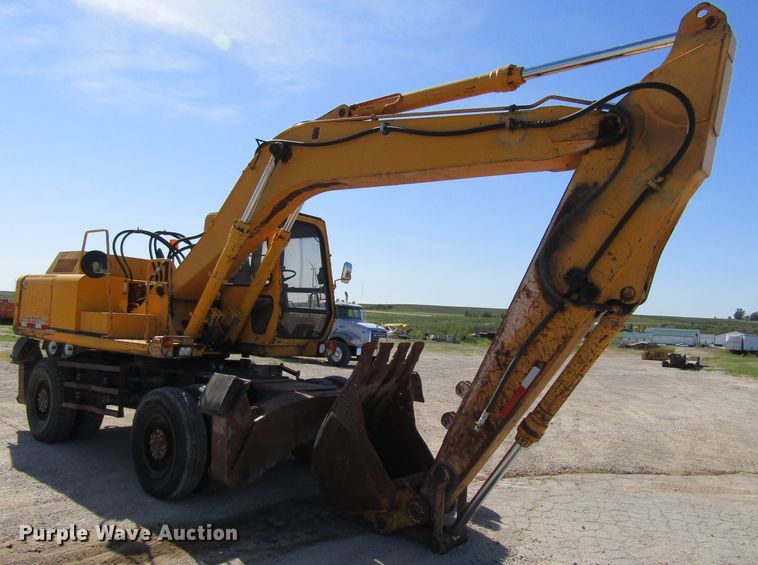 image for item GQ9085 1994 John Deere 595D  rubber tire excavator