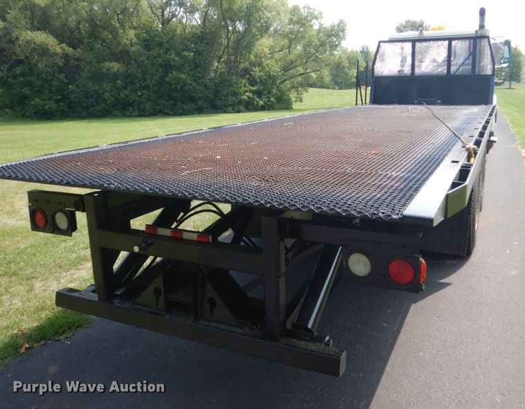 image for item FT9131 1996 Volvo WG  rollback truck