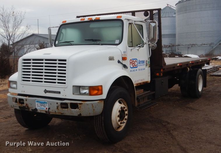 image for item HU9813 2000 International 4700  dump flatbed truck