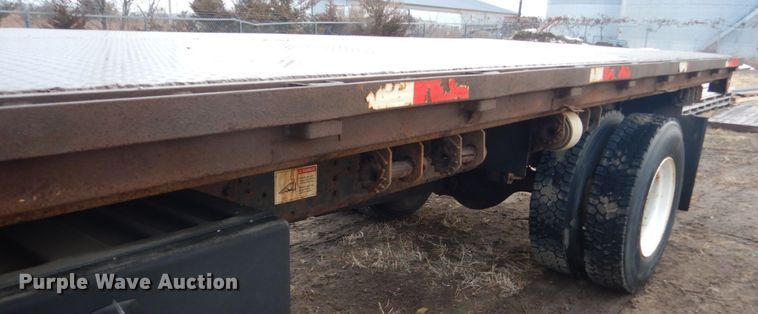 image for item HU9813 2000 International 4700  dump flatbed truck