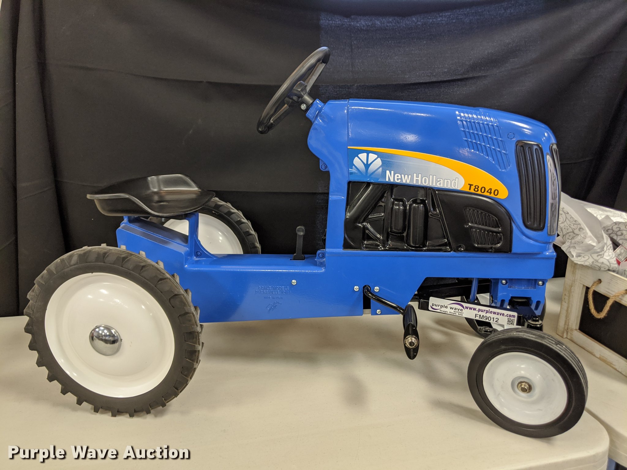 New Holland pedal tractor in Wamego, KS Item FM9012 sold Purple Wave