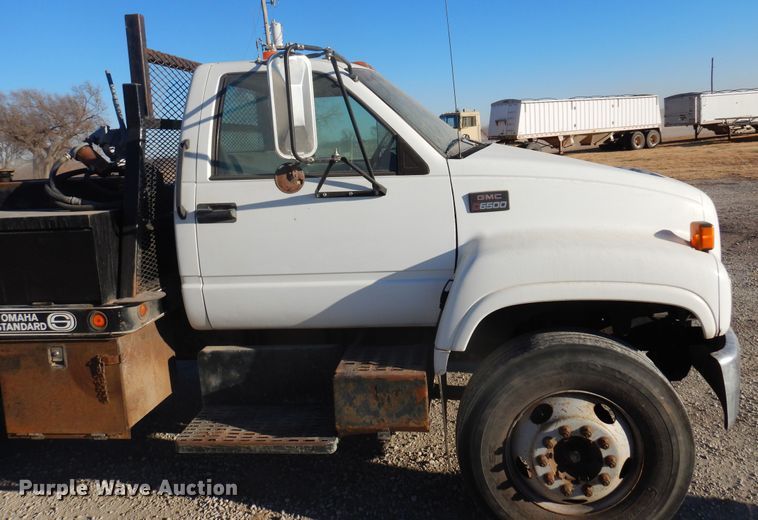 image for item JJ9832 1997 GMC C7500  flatbed truck