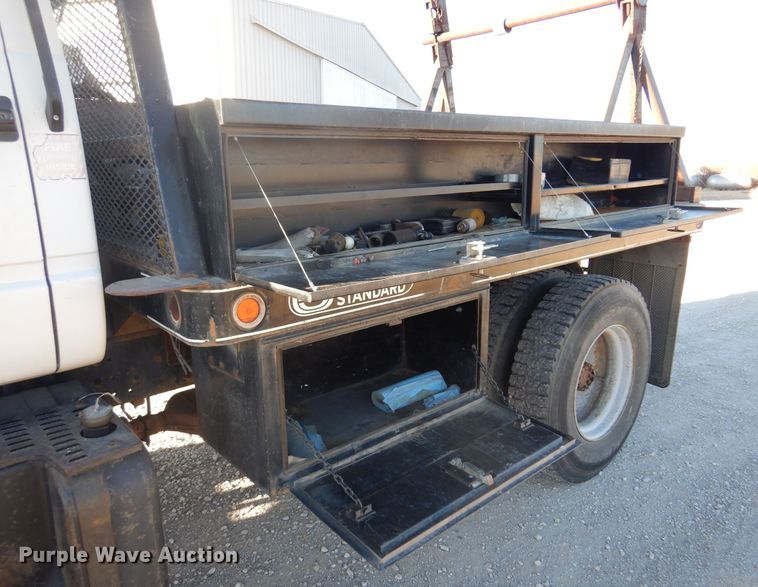 image for item JJ9832 1997 GMC C7500  flatbed truck