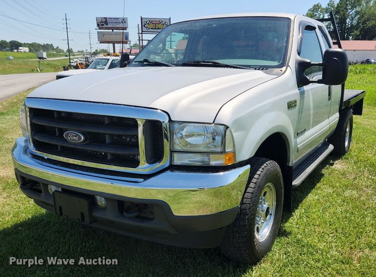 image for item JM9006 2002 Ford F250 Super Duty XLT  SuperCab flatbed pickup truck