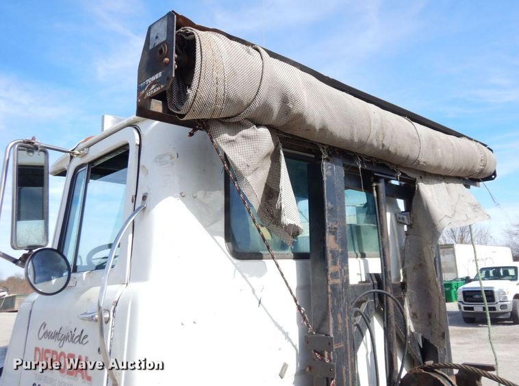 image for item DS1532 1991 Mack DM690S  roll-off container truck