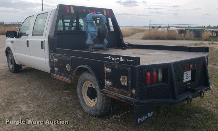 image for item DQ0571 2003 Ford F350 Super Duty  Crew Cab flatbed pickup truck