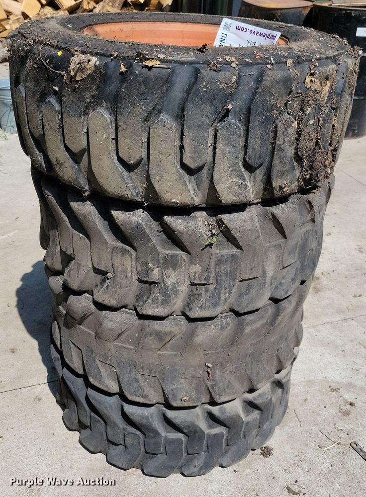 image for item DN4080 (4) 10-16.5 NHS Firestone skid steer tires and wheels