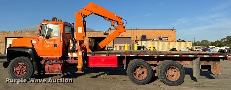 image for item DT2031 1997 Ford  LNT8000 flatbed truck with crane