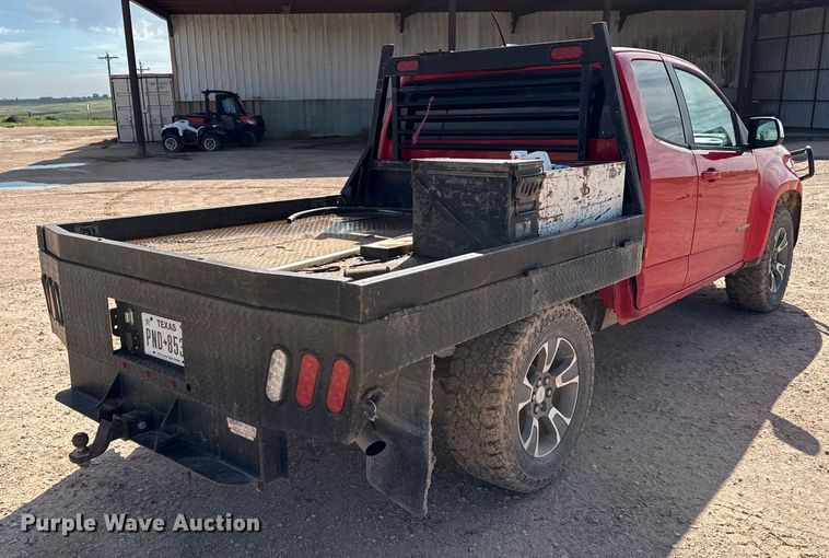 image for item EP0571 2015 Chevrolet Colorado Ext. Cab flatbed pickup truck