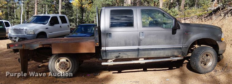 image for item EC1211 2003 Ford F250 Super Duty Crew Cab dump flatbed pickup truck