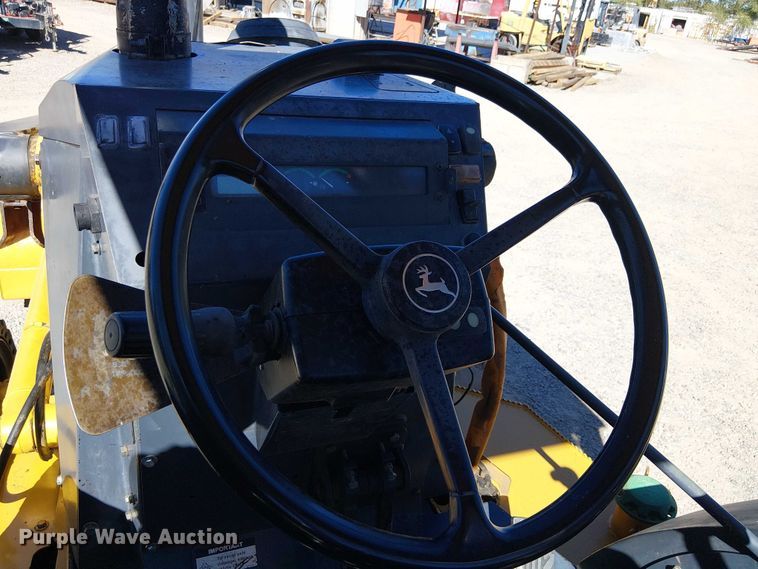 image for item EC1255 2012 John Deere 210K landscape tractor