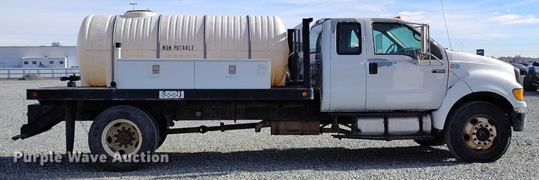 image for item YA1591 2004 Ford  F650 SuperCab flatbed truck