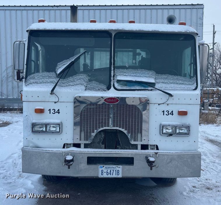 image for item DK0202 2002 Peterbilt 320 roll-off container truck