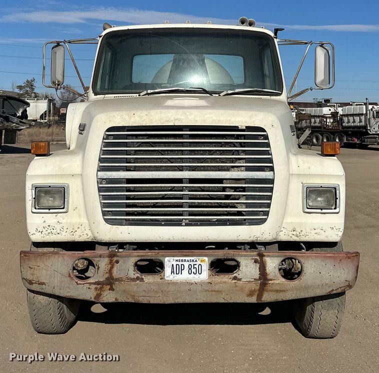 image for item ES1024 1985 Ford L7000 hook lift truck with tank