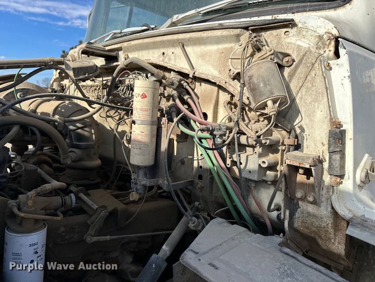 image for item ES1024 1985 Ford L7000 hook lift truck with tank