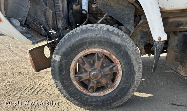 image for item ES1024 1985 Ford L7000 hook lift truck with tank