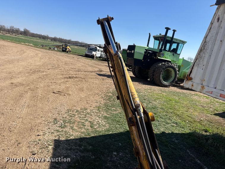 image for item ET1675 Long 1199 A skid steer backhoe