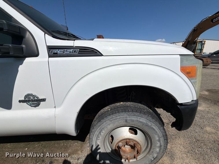 image for item EW0011 2015 Ford F350 Super Duty Crew Cab flatbed pickup truck