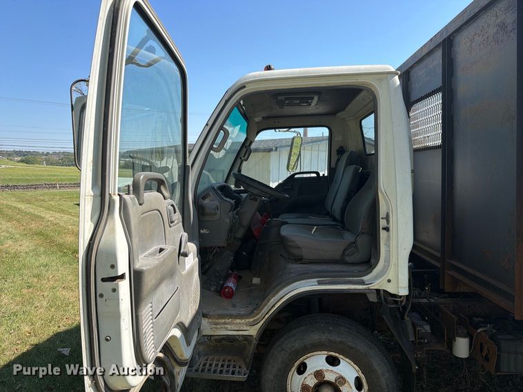 image for item FC3385 1999 Isuzu NPR flatbed truck